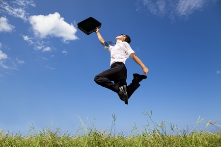 10567127 - happy and successful businessman jumping on the field motivation