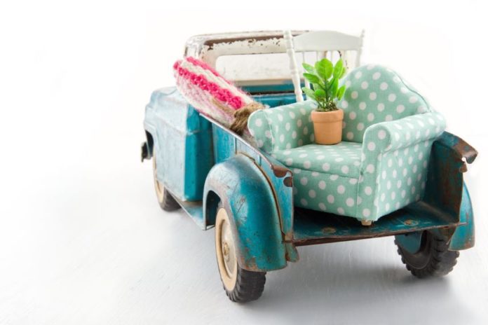 19979113 - old vintage toy truck packed with furniture - moving houses concept vintage moving truck