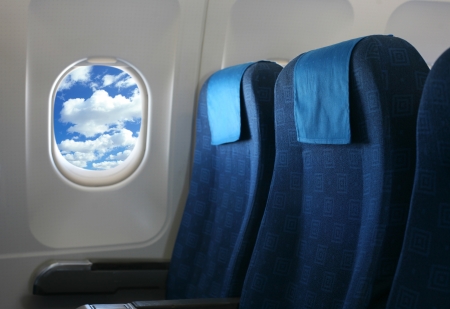 18758129 - airplane seat and window inside an aircraft with view on sea airplane seats