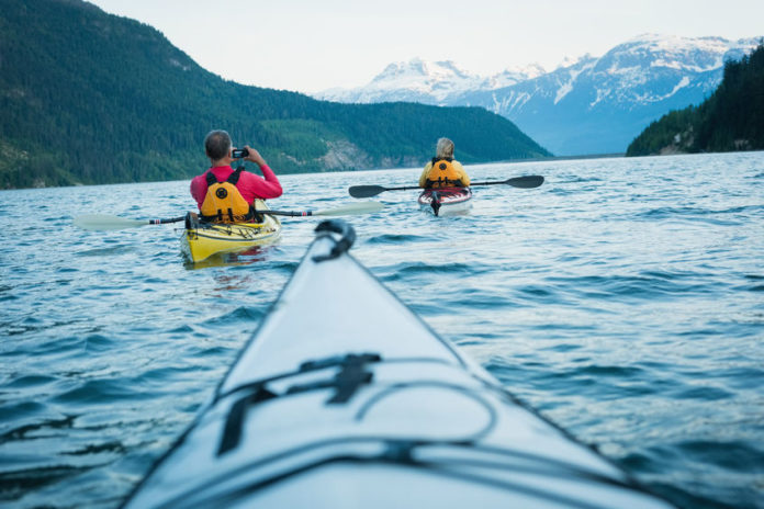 81818704 - cropped image of white kayak against mature couple kayaking in lake